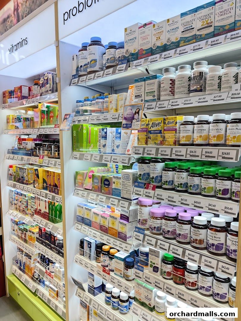 Shelves stocked with various vitamins, probiotics, and health supplements in a retail store.
