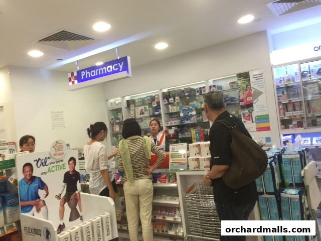Customers are being served at the pharmacy counter of Guardian Health & Beauty.