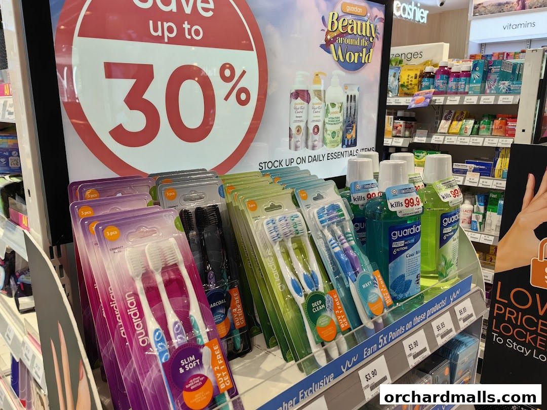 A display of Guardian brand oral care products and health items with a 'Save up to 30%' promotion.