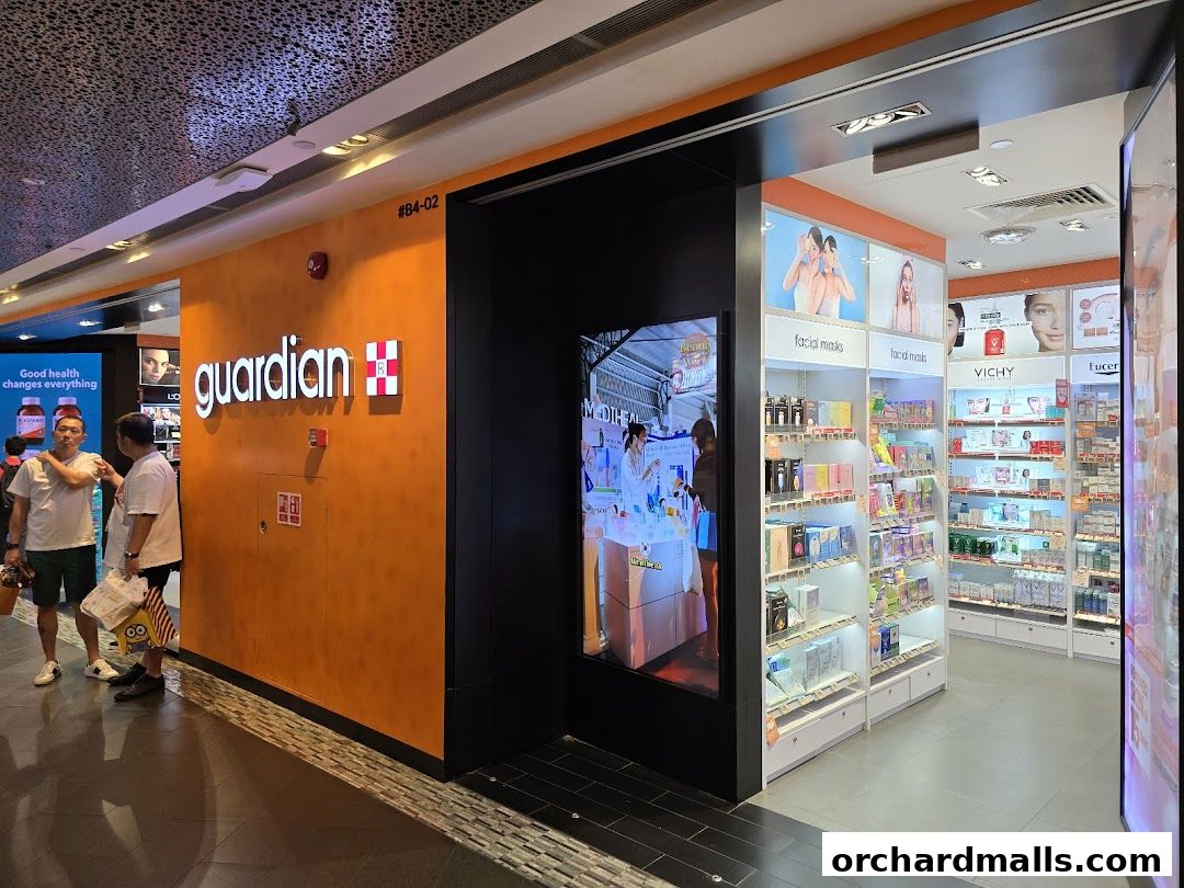 The Guardian Health & Beauty store entrance with its prominent orange signage and well-stocked shelves visible.