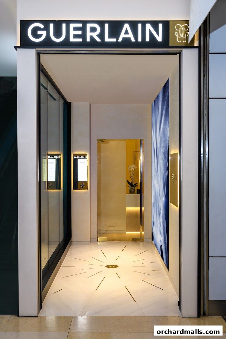 The entrance to the Guerlain Facialist Suite at Ion Orchard, featuring elegant signage and a luxurious interior.
