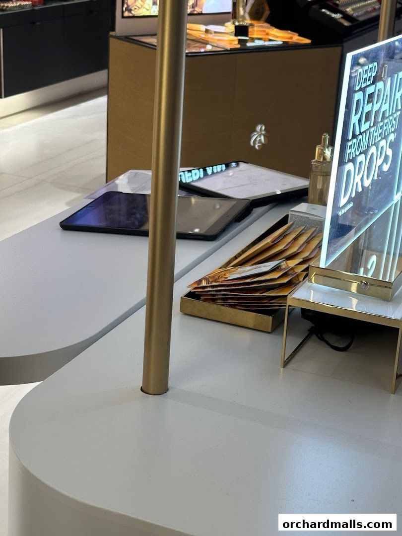 A display counter with tablets, brochures, and a sign promoting 'Deep Repair Drops'.