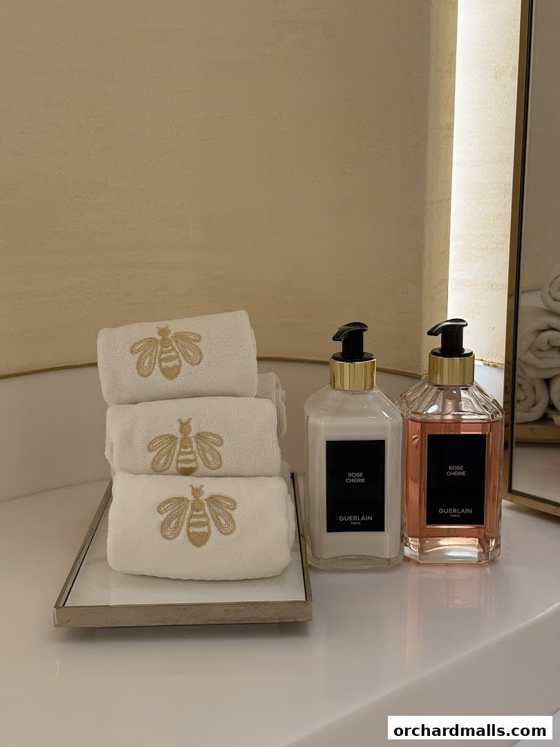 Guerlain Rose Chérie lotion and towels with bee embroidery.