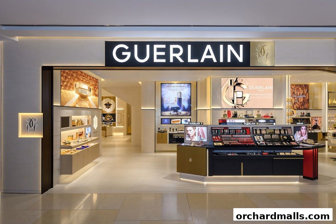 The elegant Guerlain boutique entrance showcases luxurious beauty products and illuminated displays.