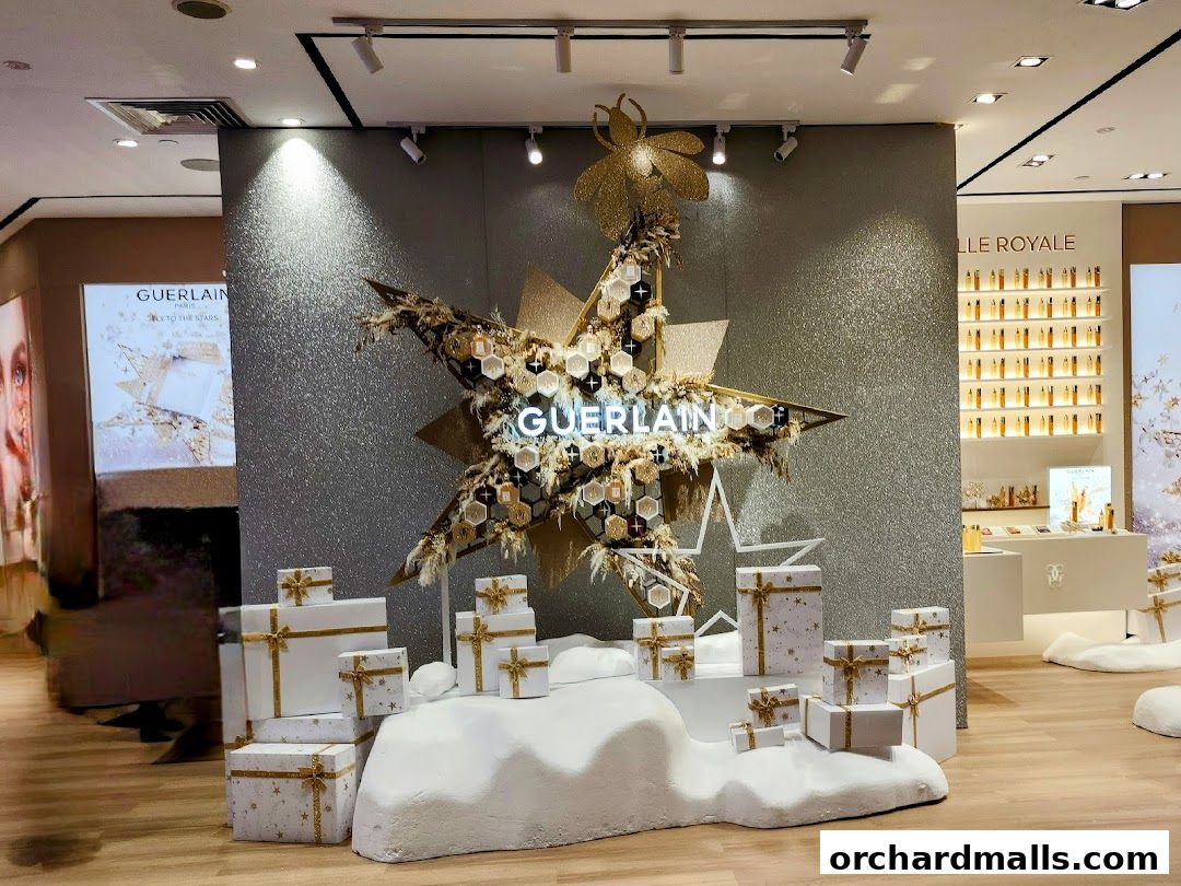 Guerlain boutique interior with festive star display and gift boxes.