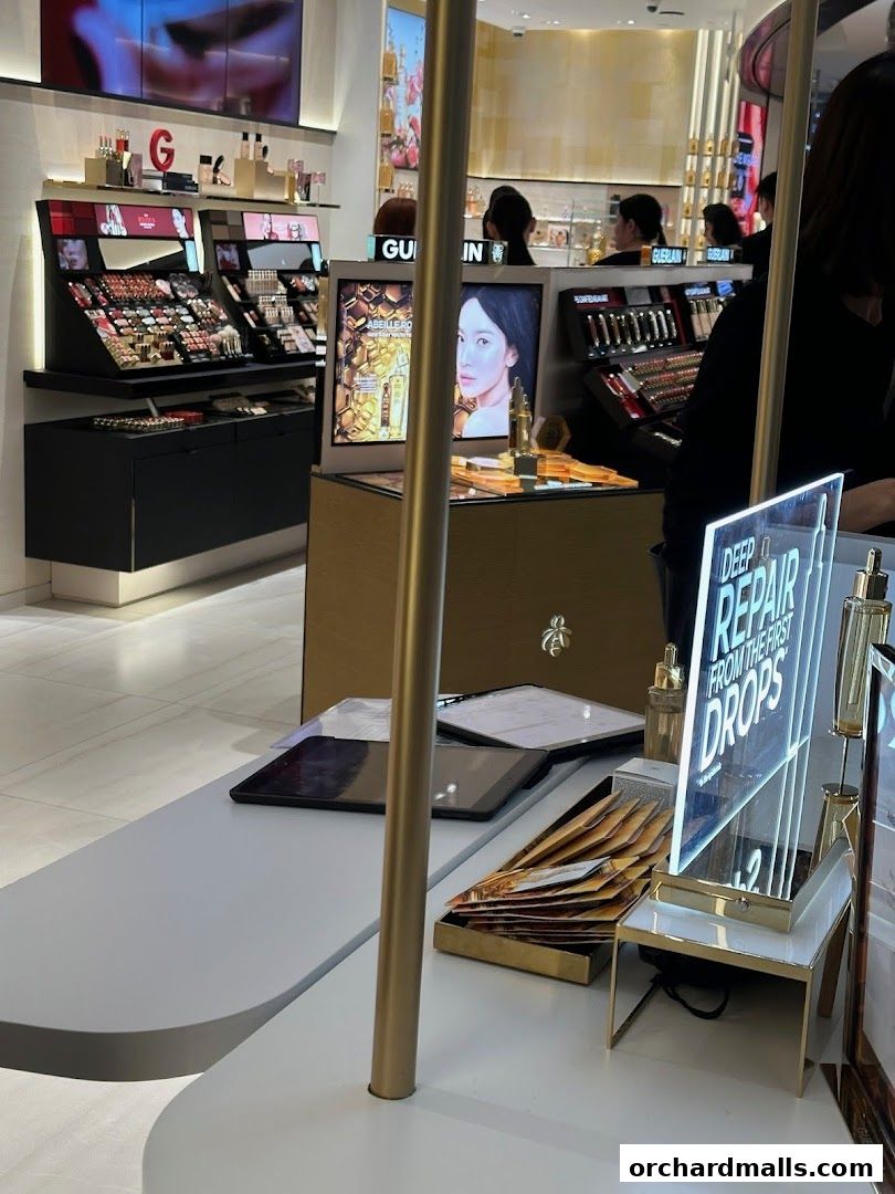 Guerlain boutique interior showcasing makeup displays and promotional materials.