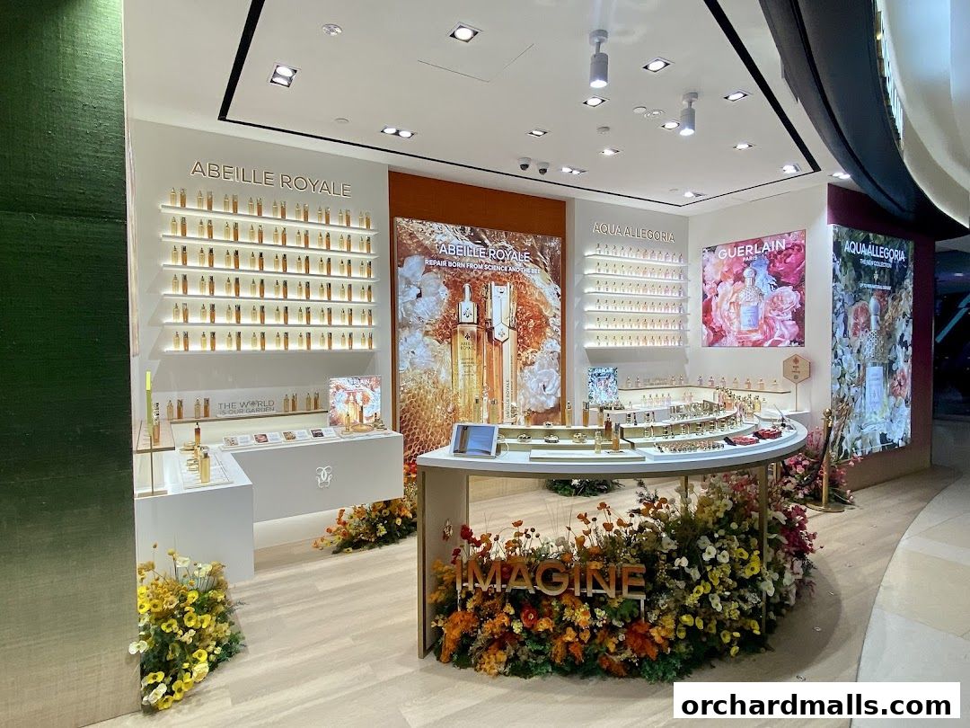 Interior of a Guerlain boutique showcasing skincare and fragrance collections with floral displays.