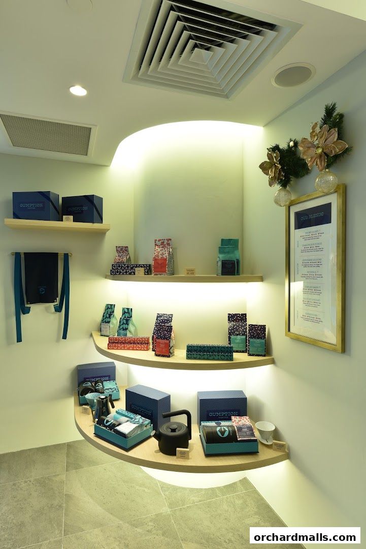 Gumption Coffee shop interior displaying coffee bags, kettles, and gift sets on shelves.