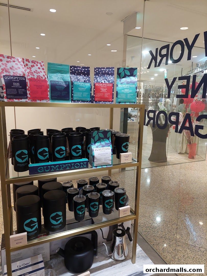Gumption Coffee shop display featuring bags of coffee and branded merchandise.
