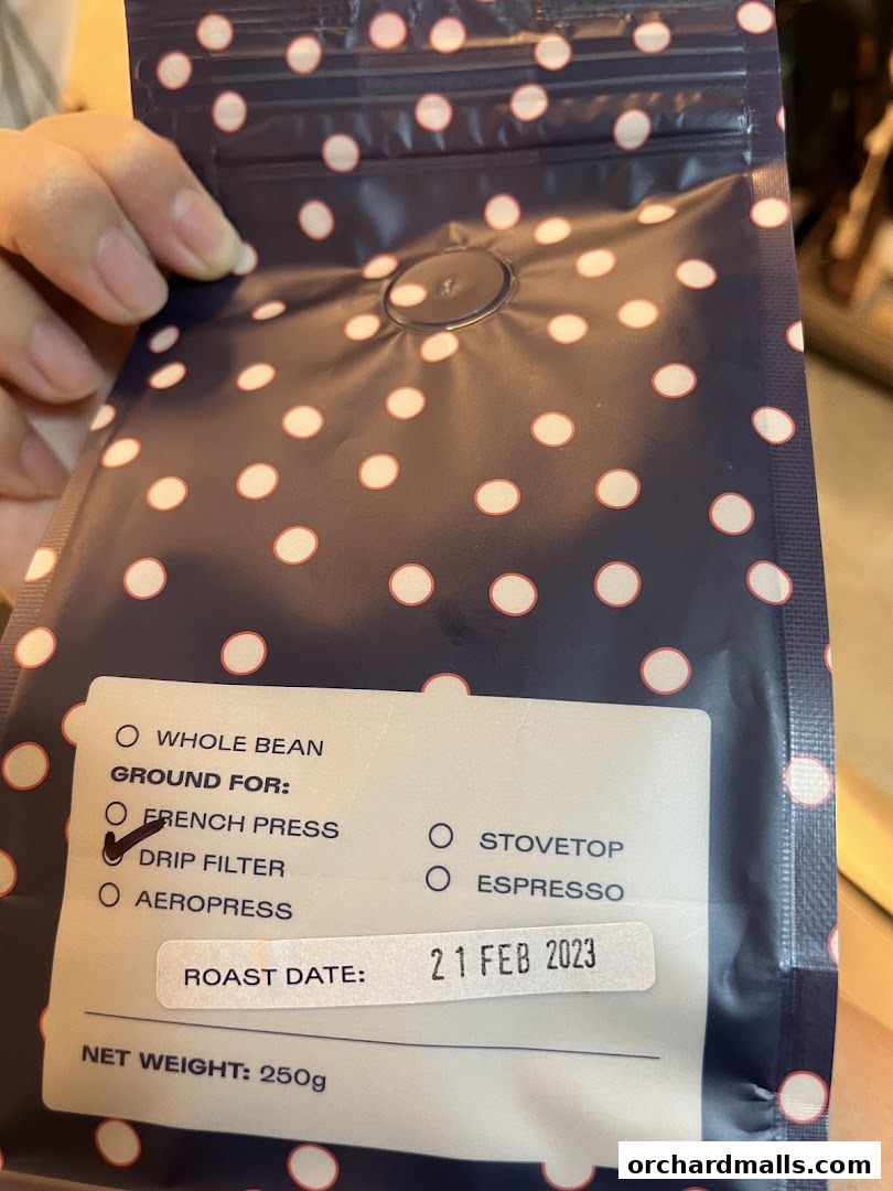 A bag of Gumption Coffee beans with roast date and net weight visible.