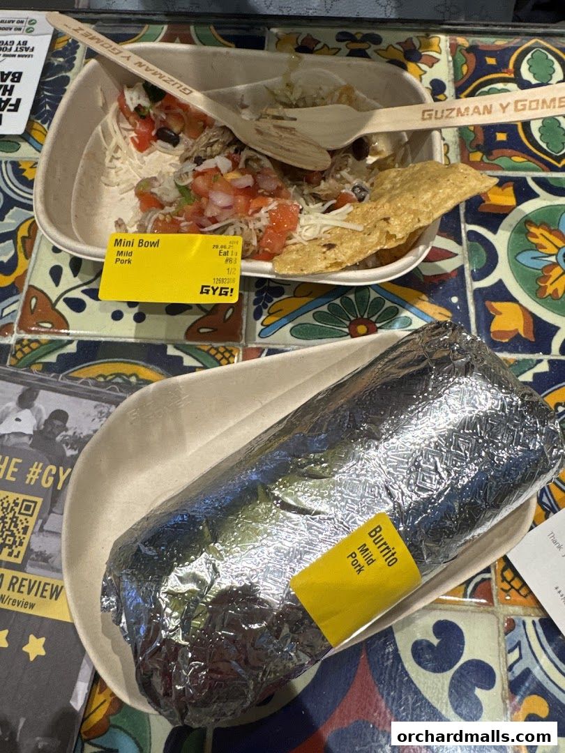 A Guzman y Gomez mini bowl and a foil-wrapped burrito with mild pork.