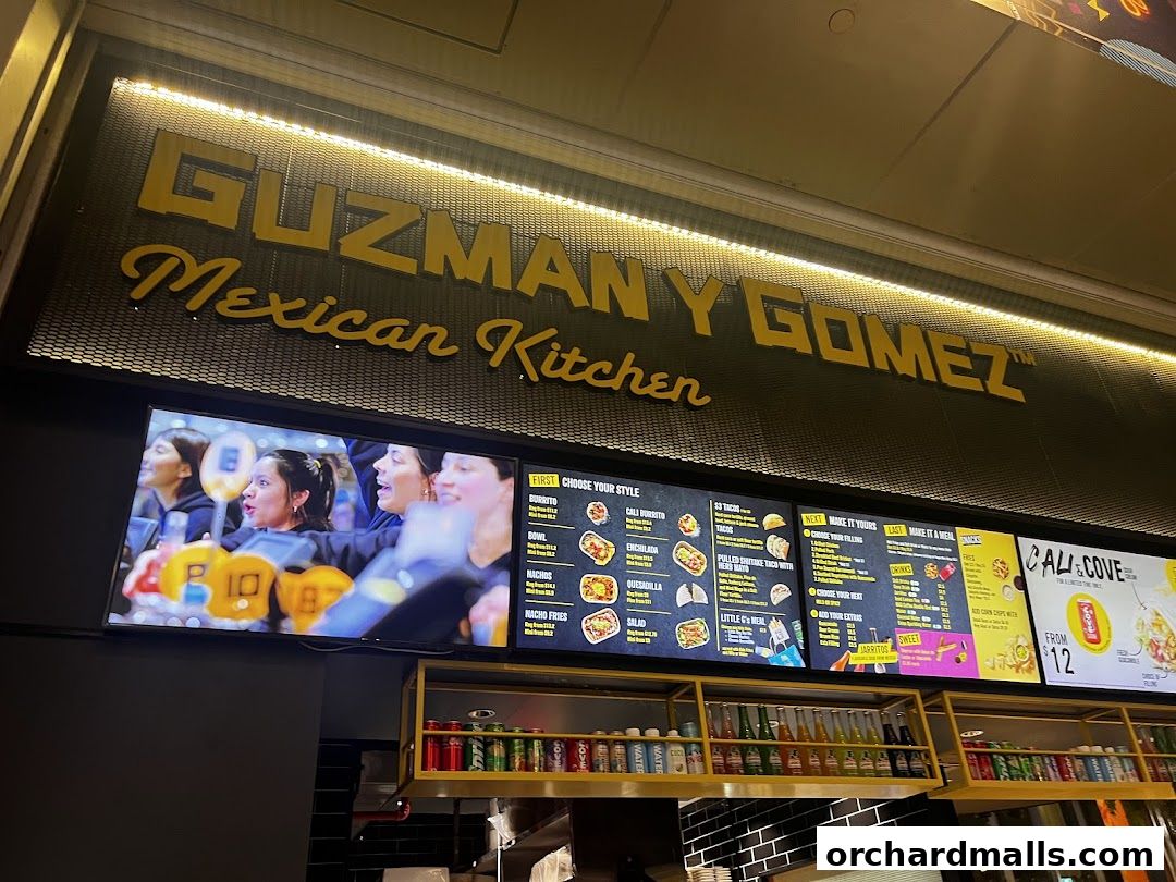 Guzman y Gomez Mexican Kitchen menu board with various food and drink options.