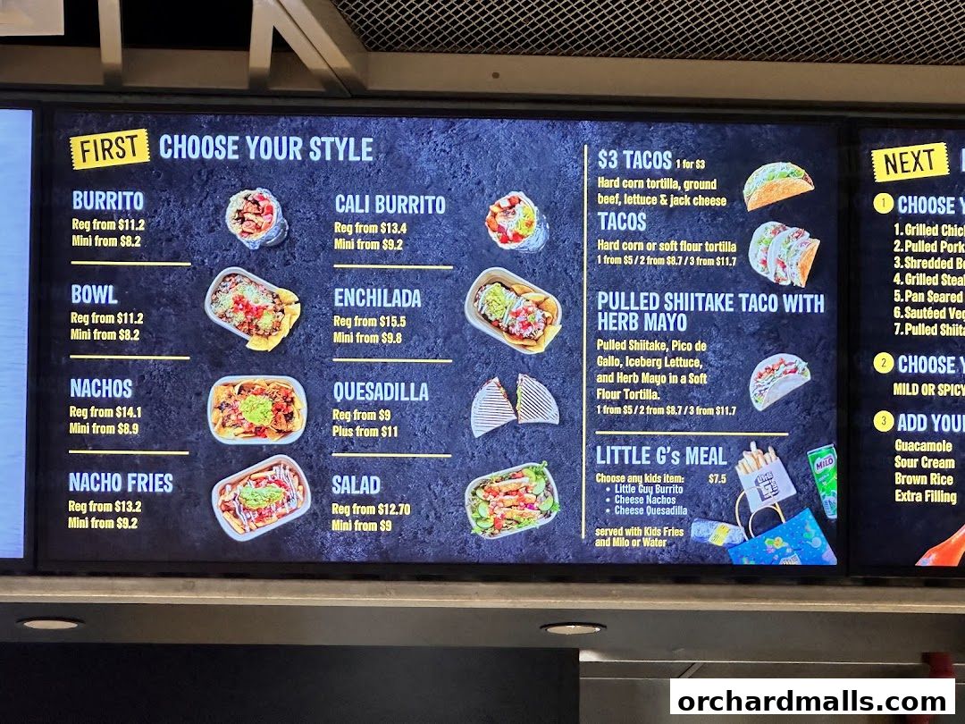 A digital menu board displaying various Mexican-inspired food options and prices.