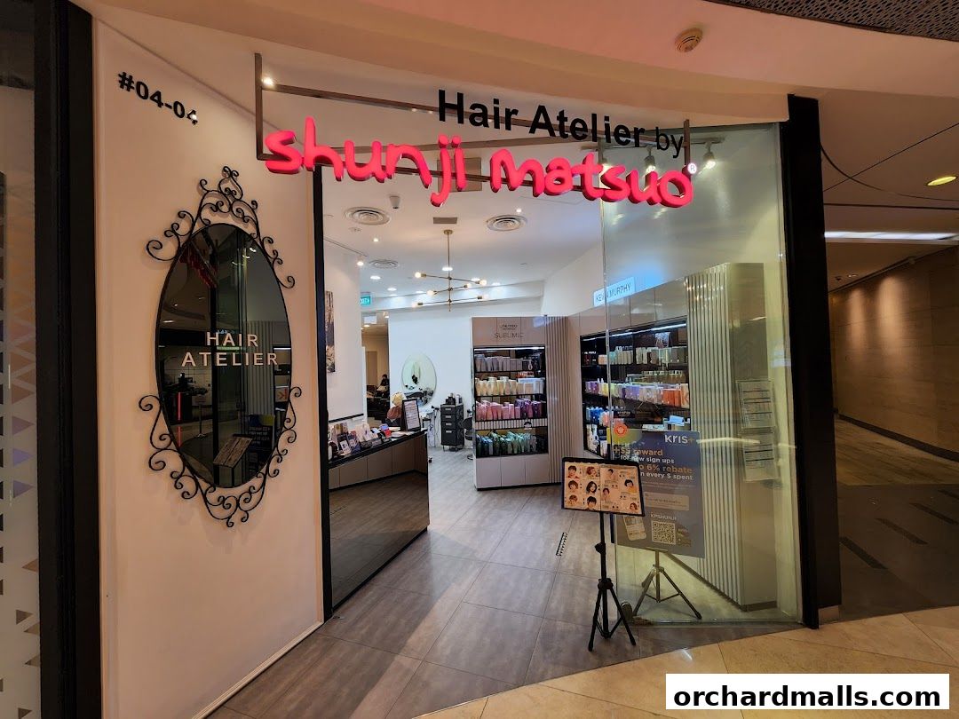 The entrance of Hair Atelier by Shunji Matsuo, showcasing salon products and a decorative mirror.