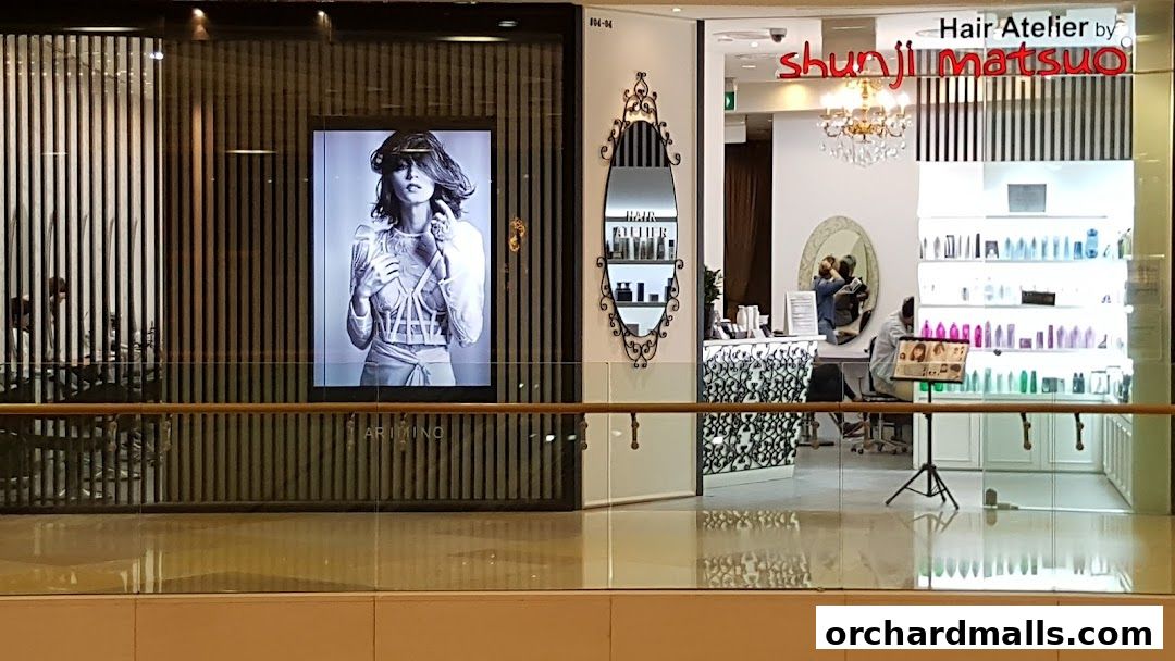 The exterior of Hair Atelier by Shunji Matsuo, featuring a stylish display and salon interior.