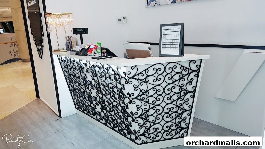 The reception desk of Hair Atelier by Shunji Matsuo, featuring an ornate design and a price list.