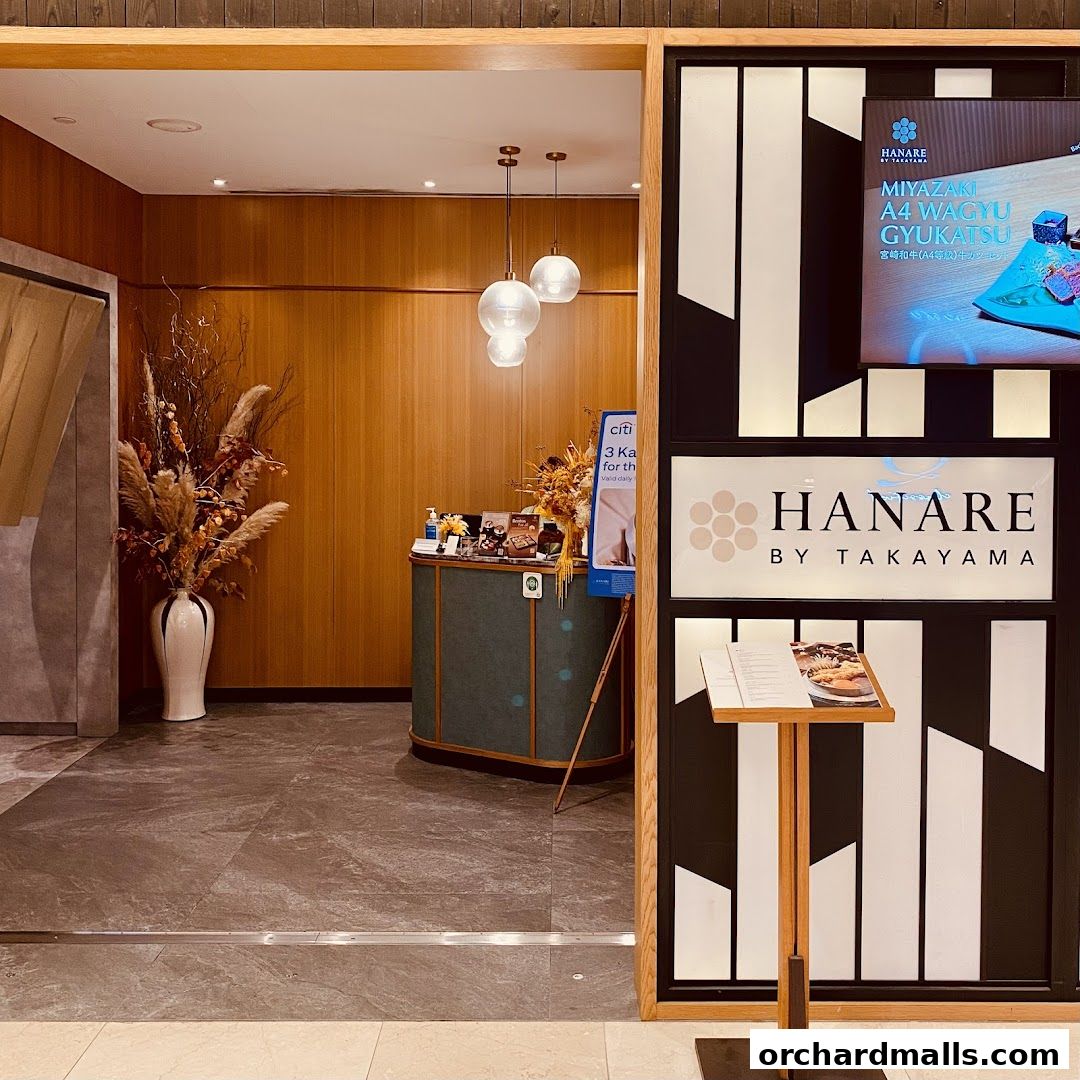 The entrance of Hanare by Takayama restaurant with a reception desk and decorative elements.