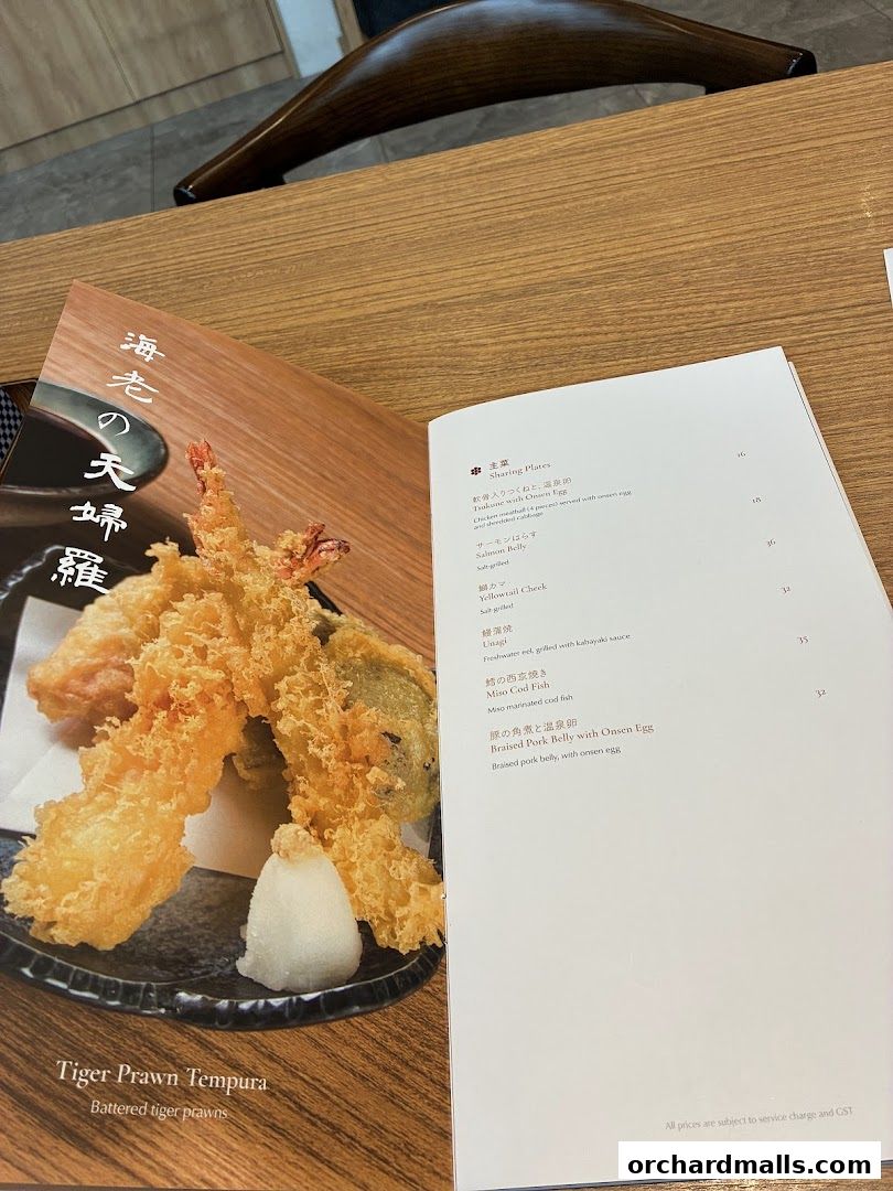 A menu featuring Tiger Prawn Tempura and other Japanese dishes.