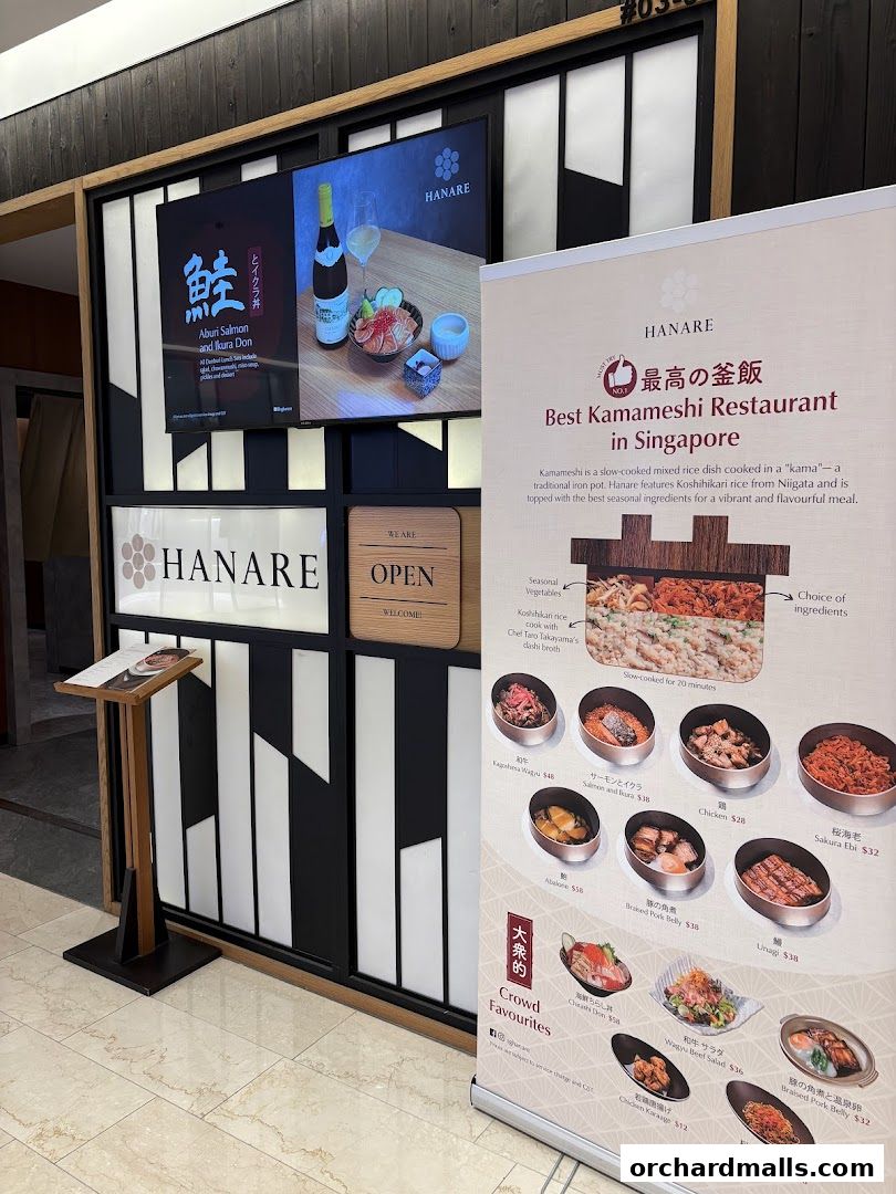 Hanare restaurant entrance with a digital display and a promotional banner showcasing menu items.