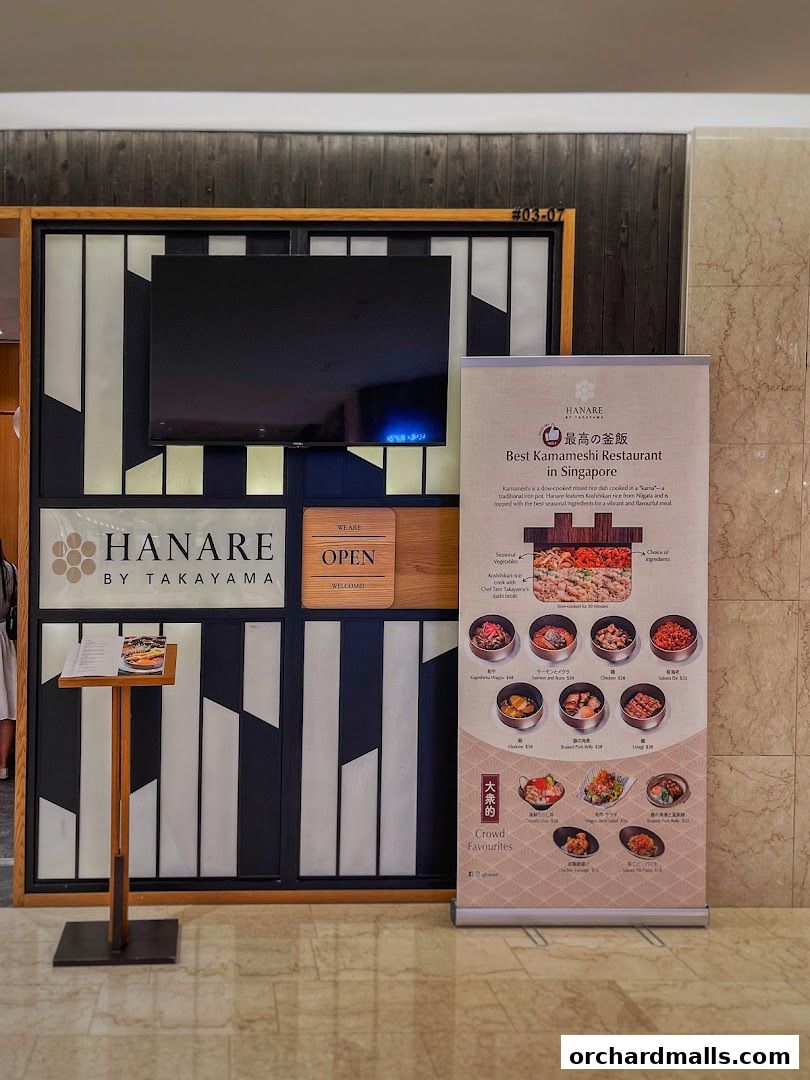The entrance of Hanare by Takayama, a Japanese restaurant, with a menu display.