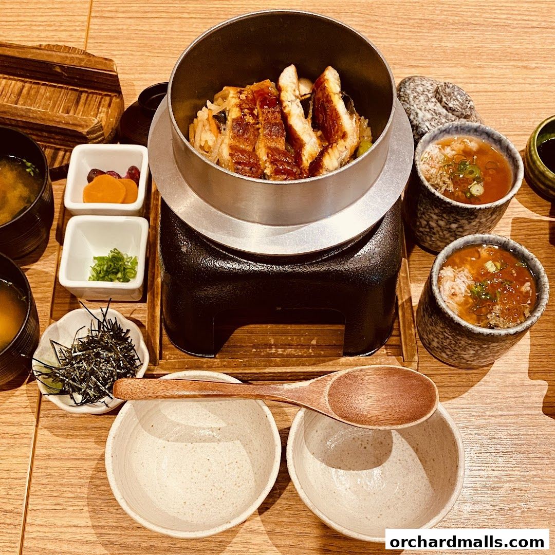 A delicious meal featuring grilled eel over rice, served with miso soup and side dishes.