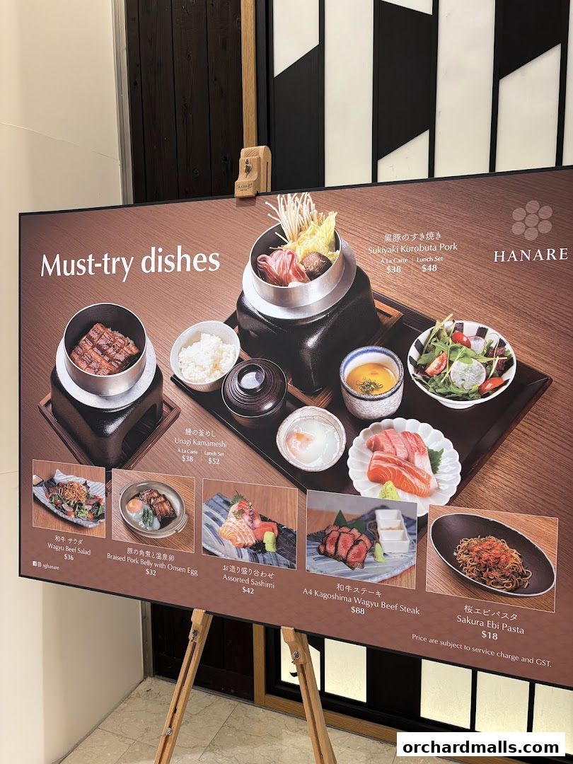 A display board showcasing 'Must-try dishes' from the restaurant Hanare.