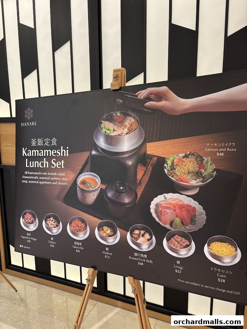 A display board showcasing the Kamameshi Lunch Set from Hanare with various dish options.