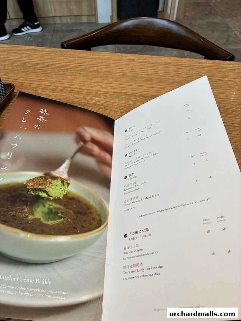 A menu featuring Matcha Crème Brûlée and various drinks like beer, whisky, shochu, and liqueurs.
