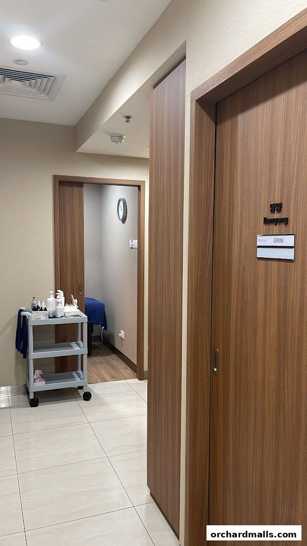 Interior view of a spa with treatment rooms and a trolley of products.