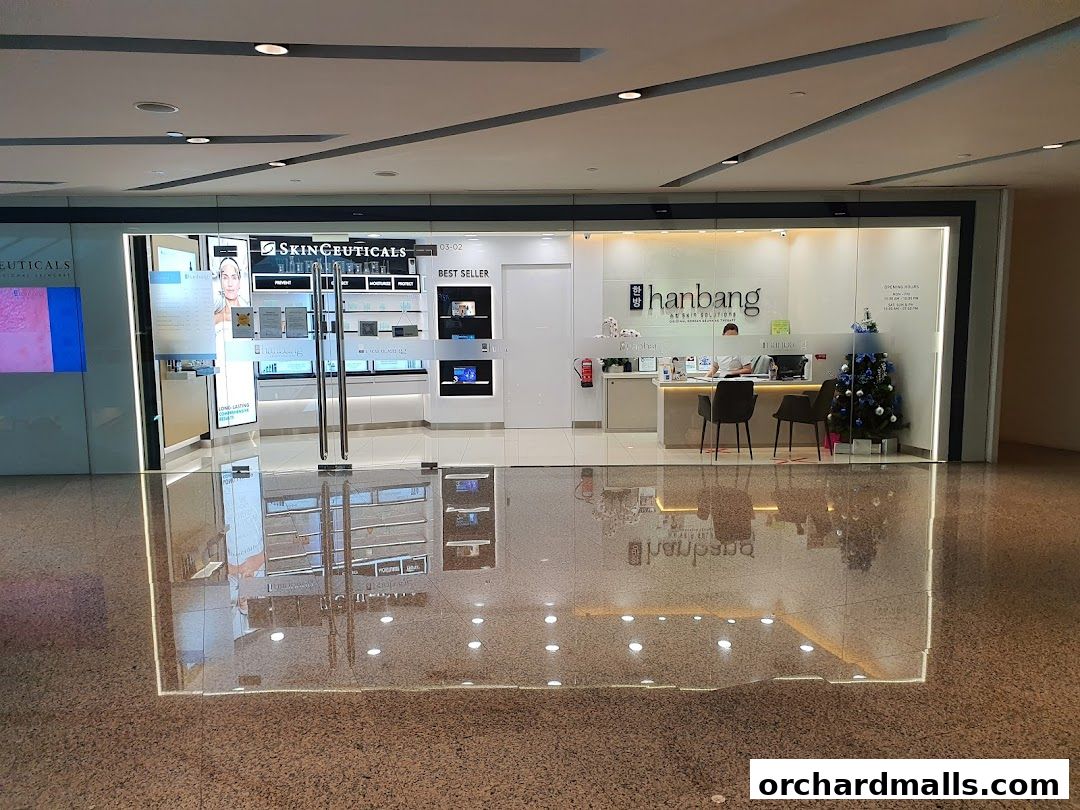 The exterior of the Hanbang Skin Solutions shop with a reception desk and product displays.