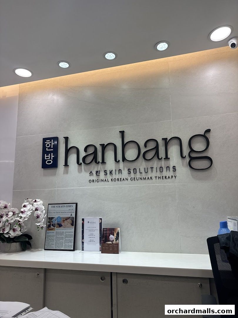 The reception area of Hanbang Skin Solutions, featuring the shop's logo and promotional materials.