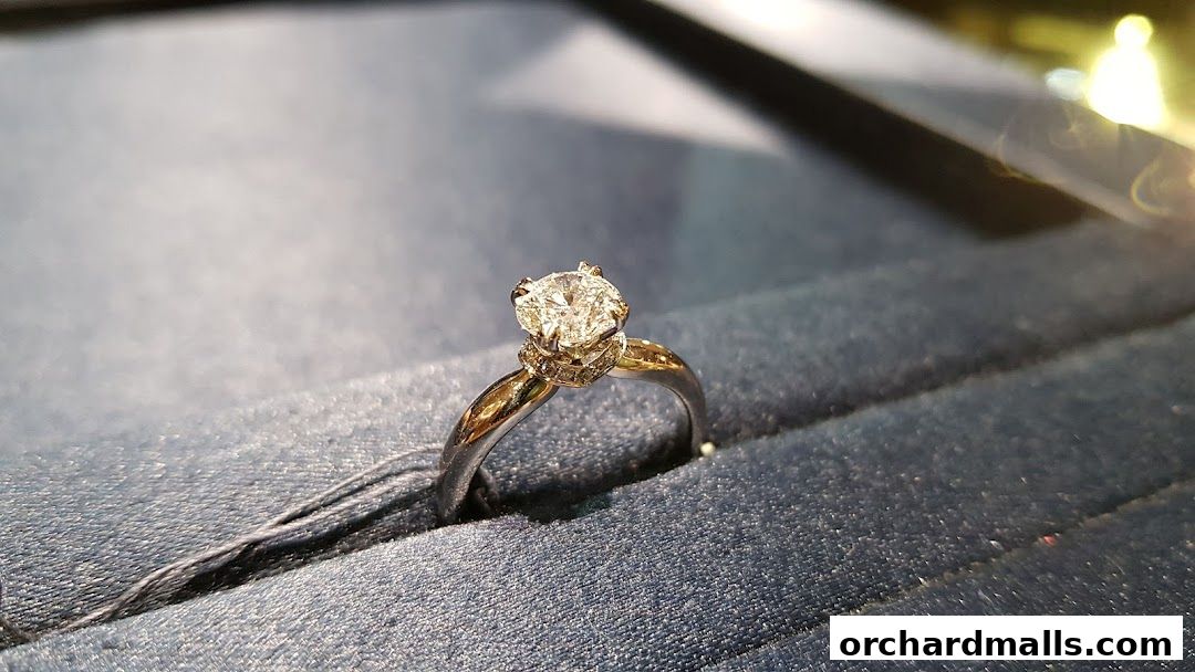 A close-up shot of a sparkling diamond engagement ring in a velvet display box.