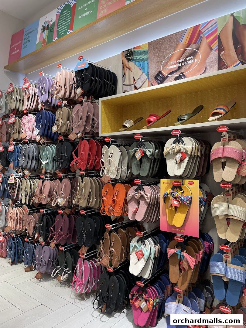 A wide selection of colorful Havaianas flip-flops and sandals displayed on shelves.