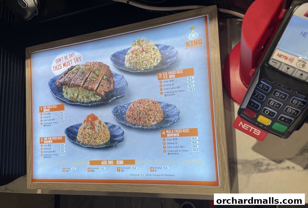 A menu board displaying various fried rice dishes with toppings and prices.