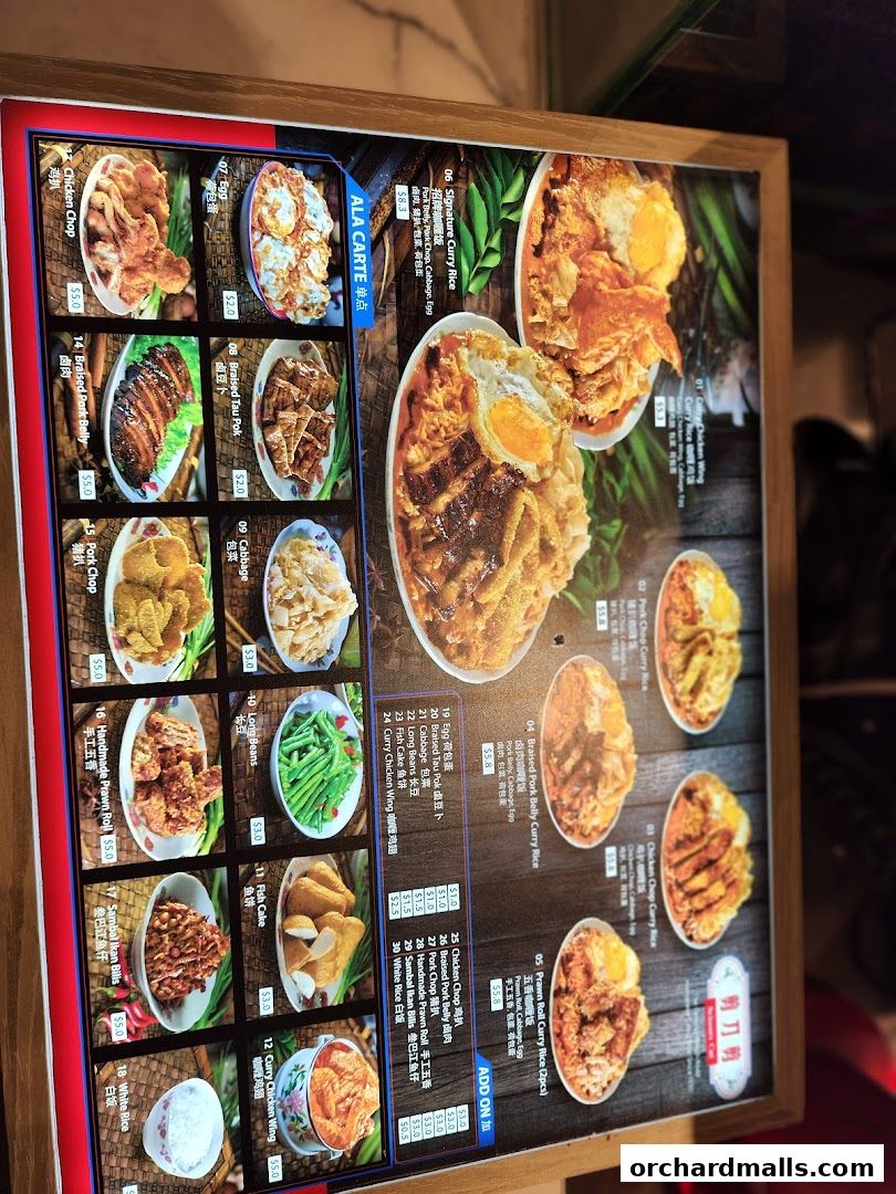A menu board displaying various curry rice dishes and side orders with images and prices.