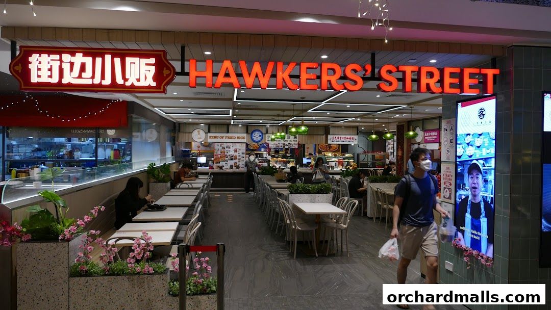 The entrance to Hawkers Street ION food court, with seating and various food stalls visible.