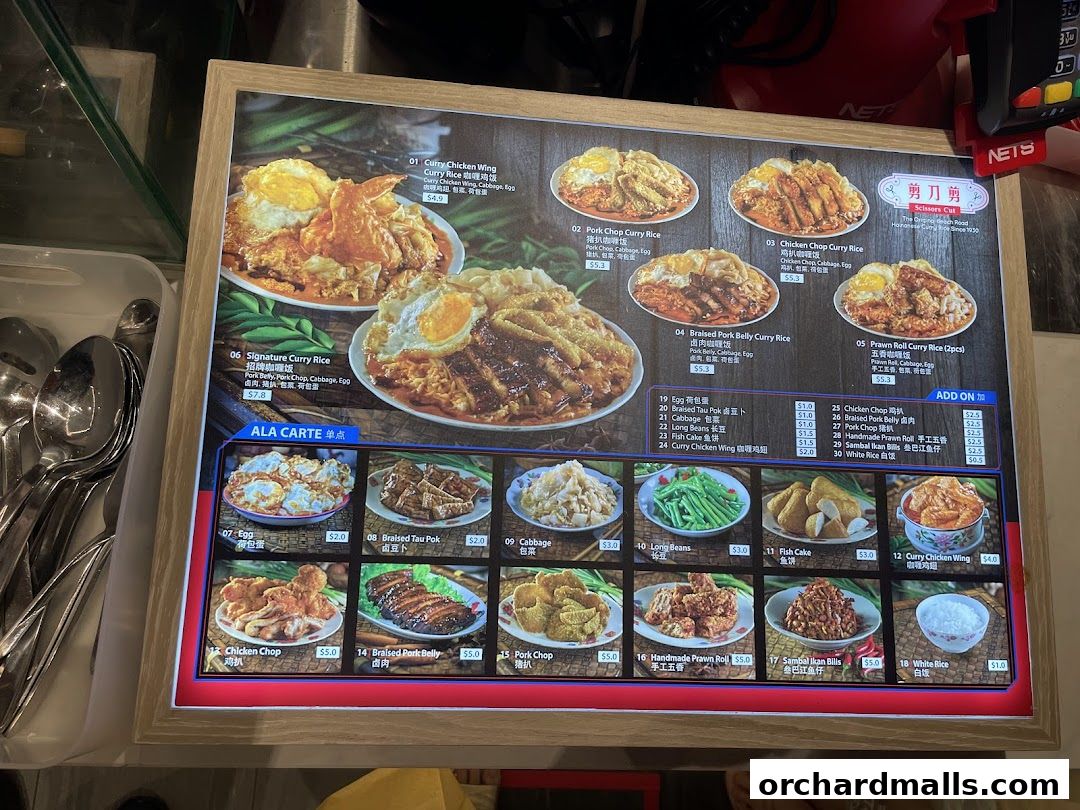A menu board displaying various curry rice dishes and a la carte options with images and prices.
