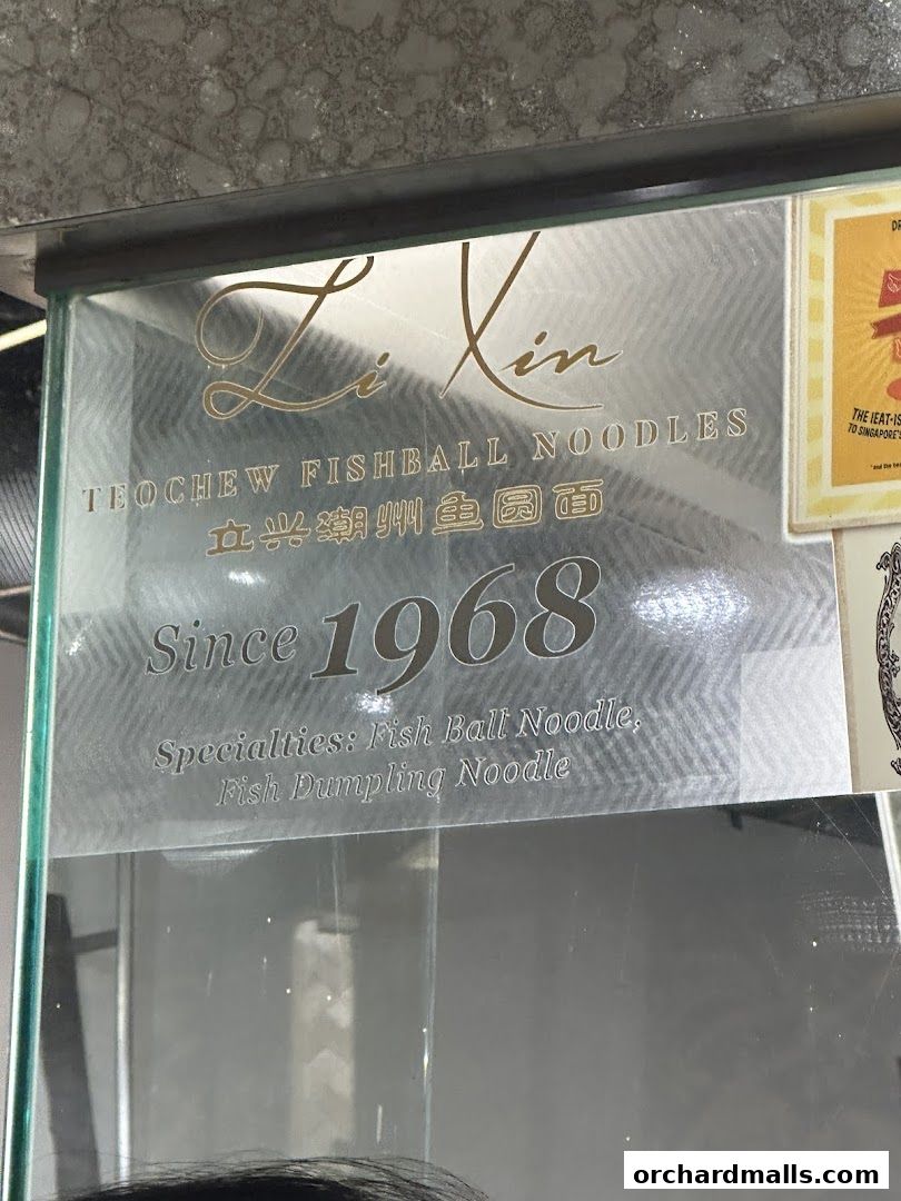 A sign for Li Xin Teochew Fishball Noodles, established in 1968.
