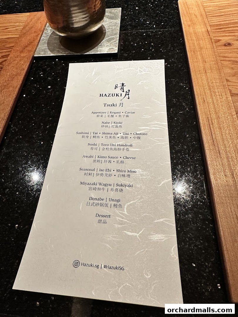 A menu from Hazuki restaurant featuring Japanese dishes like sashimi, sushi, and wagyu.