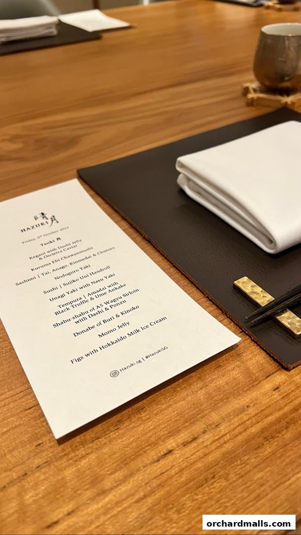 A menu from Hazuki restaurant featuring a tasting menu with various Japanese dishes.