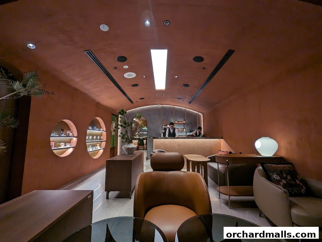 Interior view of a stylish cafe with warm lighting and comfortable seating.