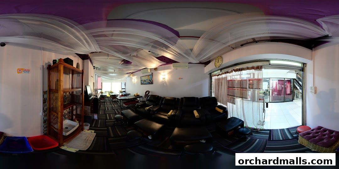 Interior of a foot massage parlor with reclining chairs and massage tables.