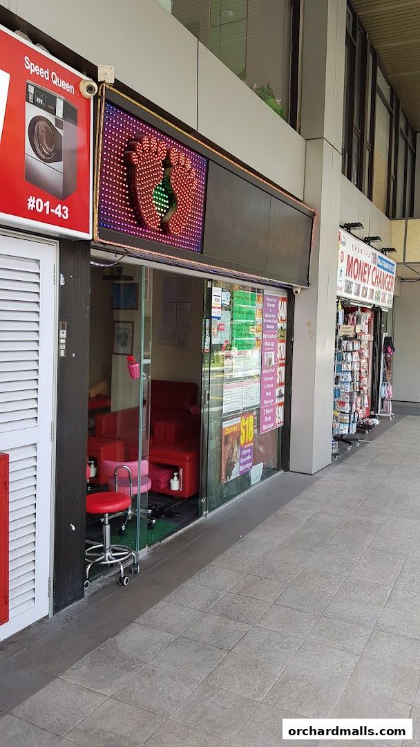 Exterior of Herbal Footcare shop with a sign featuring feet and various service price lists.