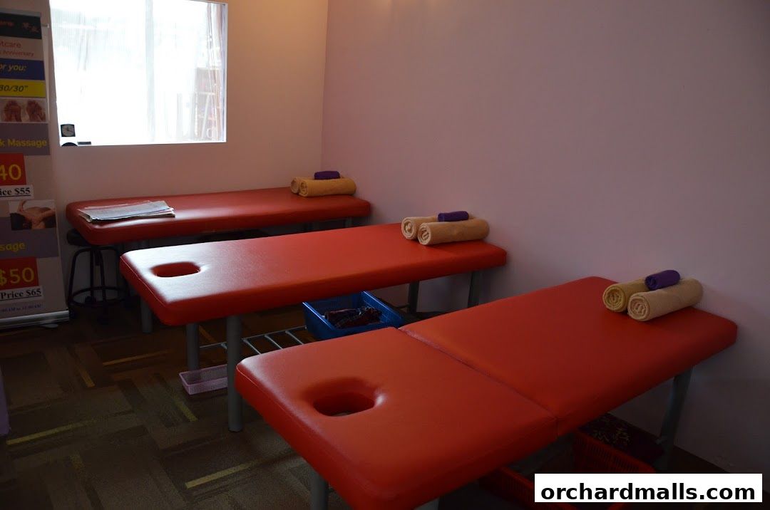 Three massage beds with towels are arranged in a room at Herbal Footcare.