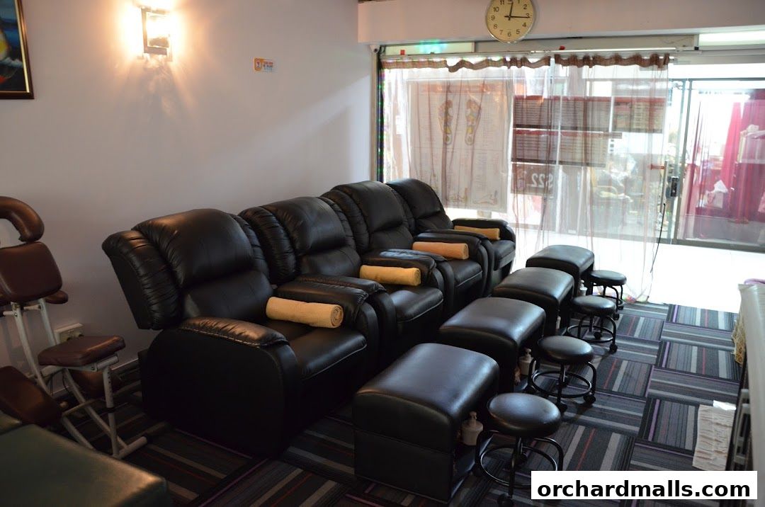 Comfortable reclining chairs and footrests arranged for foot massages in a spa.