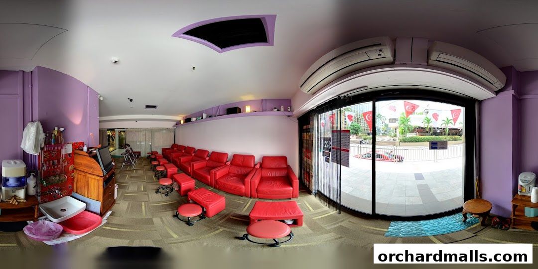 Interior of a foot spa with red recliners and foot baths.