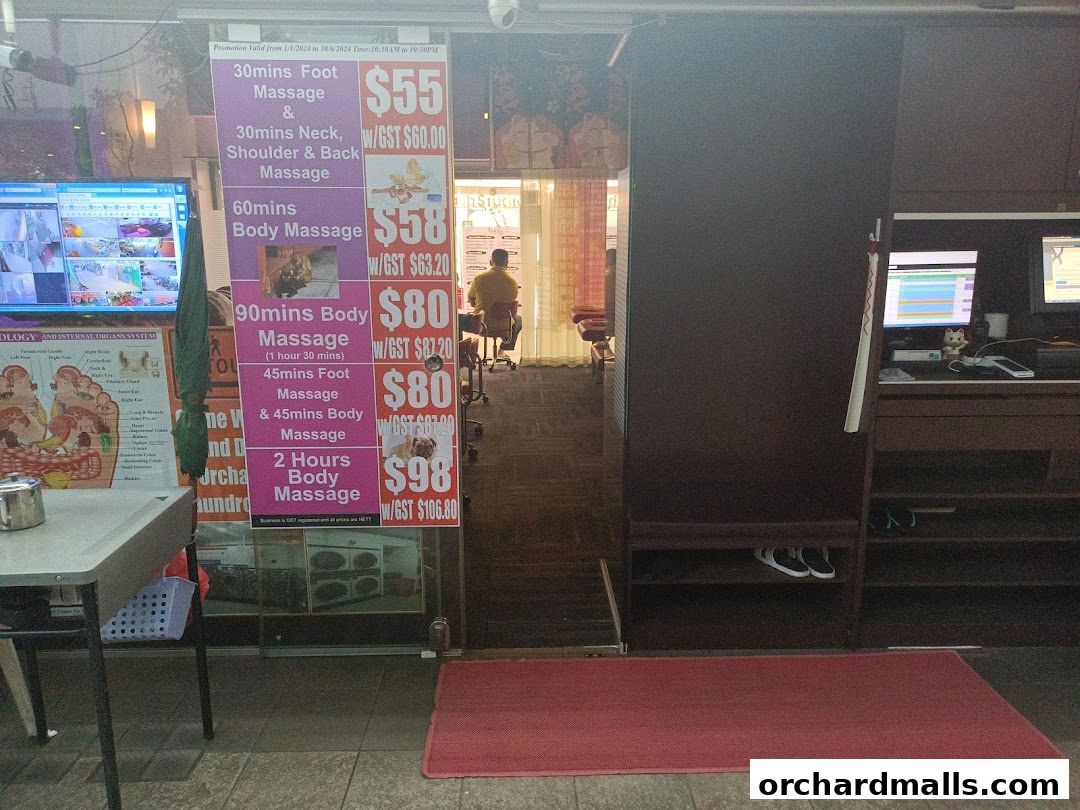 A shop front with a price list for foot and body massages displayed.