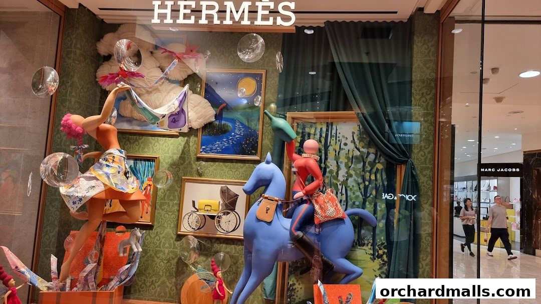 Hermès Singapore Takashimaya window display featuring whimsical figures and artwork.