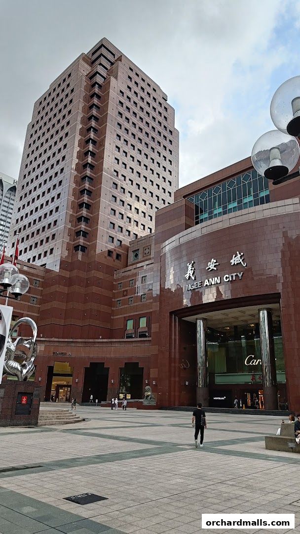 Exterior view of Ngee Ann City building with shops like Cartier and Montblanc visible.