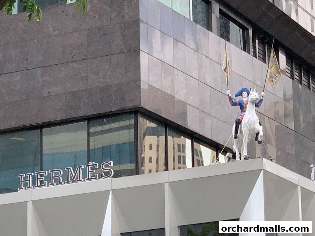 Hermès Singapore Takashimaya storefront with a statue of a rider on a horse.